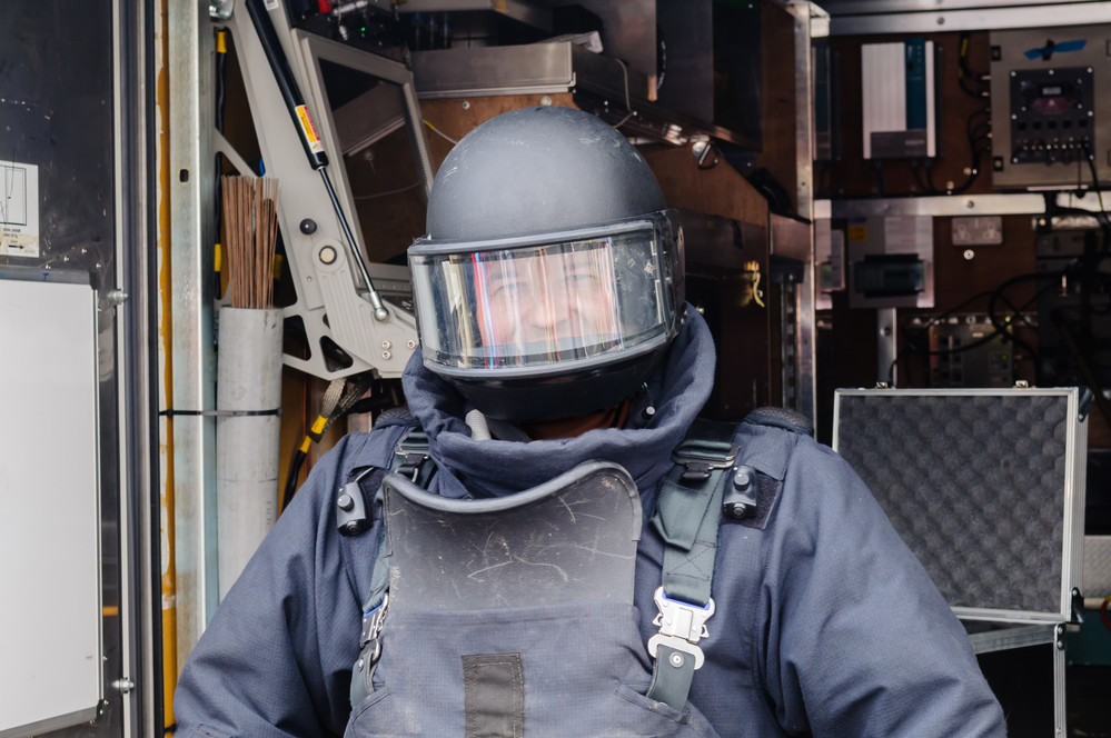 bomb-proof helmet with shield A man wearing a bomb-proof helmet with shield
