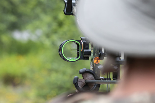 Bow Site Shooting a Compound Bow with sight that uses colored fibers