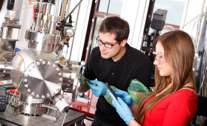 scientist looking to the laser deposition chamber